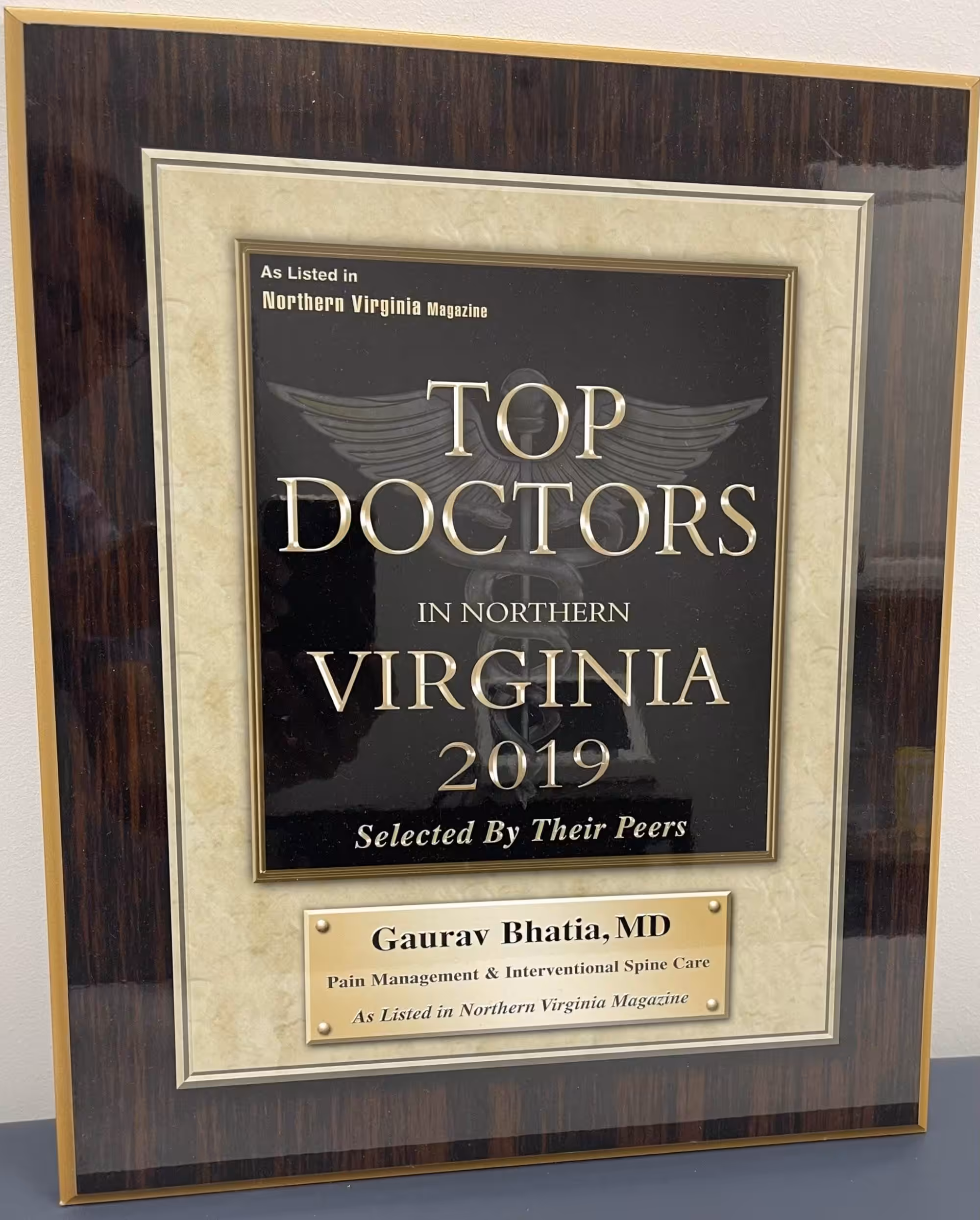 A plaque from Northern Virginia Magazine displaying "Top Doctors in Northern Virginia 2019" awarded to Gaurav Bhatia, MD for Pain Management and Interventional Spine Care.